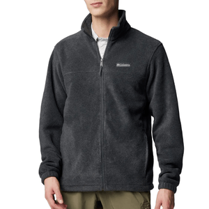 A dark gray fleece jacket with a full-zip front, high collar, and a logo on the chest, paired with khaki pants.