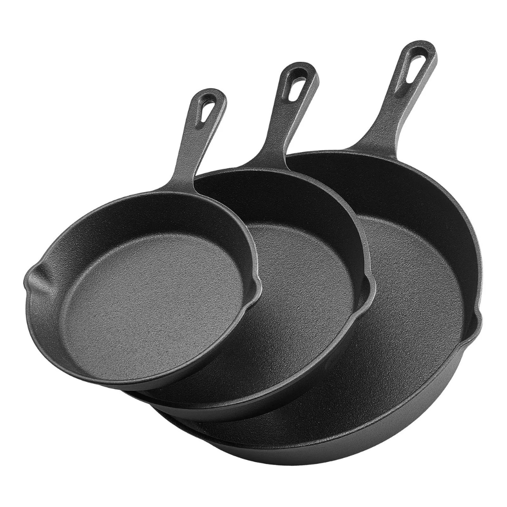 Three nested cast iron skillets with handles, showcasing varying sizes.