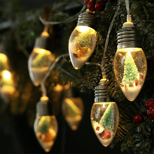 String lights featuring bulb-shaped ornaments with miniature snow scenes inside, including tiny trees and candy canes, illuminated with soft, warm lighting.