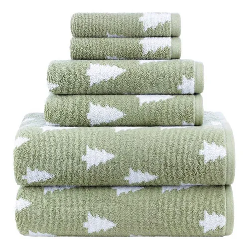 Stacked green towels with white tree patterns in various sizes.