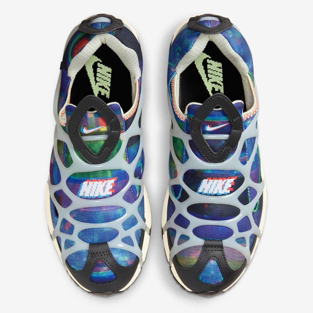 A pair of Nike sandals with a colorful, wavy pattern and adjustable straps on the top.