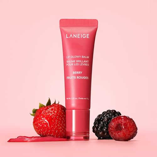 A tube of Laneige Lip Glowy Balm in Berry flavor is displayed alongside a strawberry and a blackberry, suggesting the balm's fruity ingredients.