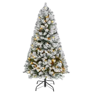 Artificial Christmas tree, snow-flocked branches, pre-lit with warm white lights, mounted on a metal stand.