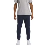 A person is wearing a grey t-shirt, navy joggers with a small logo, and white sneakers with visible logos.