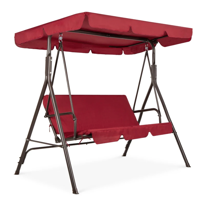 A red outdoor porch swing with an adjustable canopy and metal frame, designed for seating in a garden or patio.