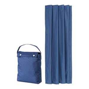 Folded blue curtain panels next to their matching carrying bag.