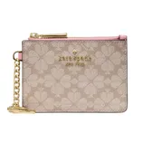 A Kate Spade New York pouch with a pink zipper, gold hardware, and a chain. The design features a floral pattern on a beige background.