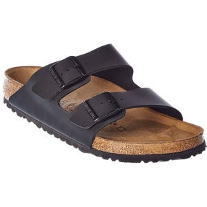 Birkenstock Arizona sandals feature two adjustable black straps with buckles over a cork footbed and a textured outsole.