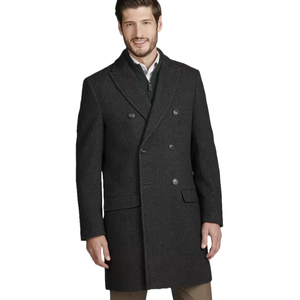 A man is wearing a dark charcoal double-breasted overcoat with matching buttons, over a shirt and sweater, paired with tan pants.