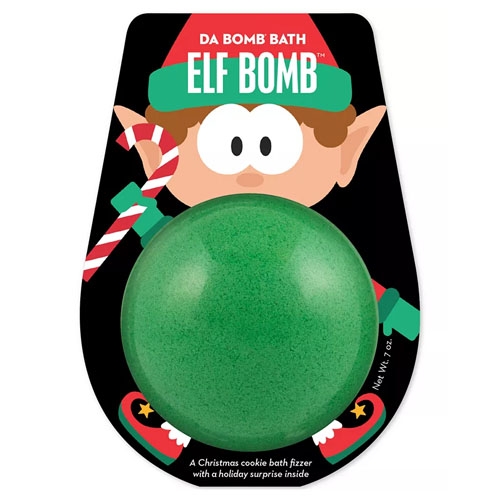 Da Bomb Elf Bath Bomb is a green bath fizzer with a Christmas cookie scent, featuring a holiday surprise inside. The packaging includes an illustration of an elf holding a candy cane.