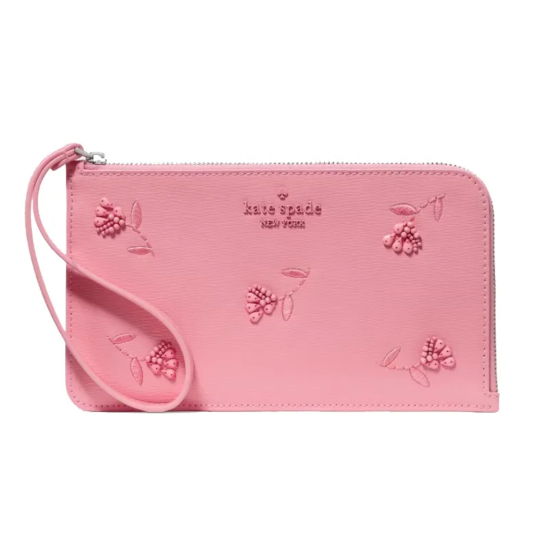 Pink zippered wristlet with embossed floral designs, featuring the \“kate spade new york\“ logo.