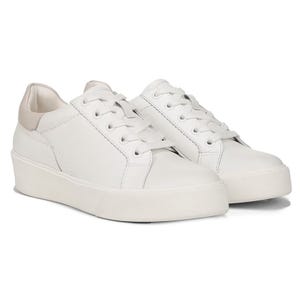 Naturalizer Marisol Sneakers are white lace-up shoes with a sleek design featuring subtle stitch detailing and a slightly raised sole for added comfort.
