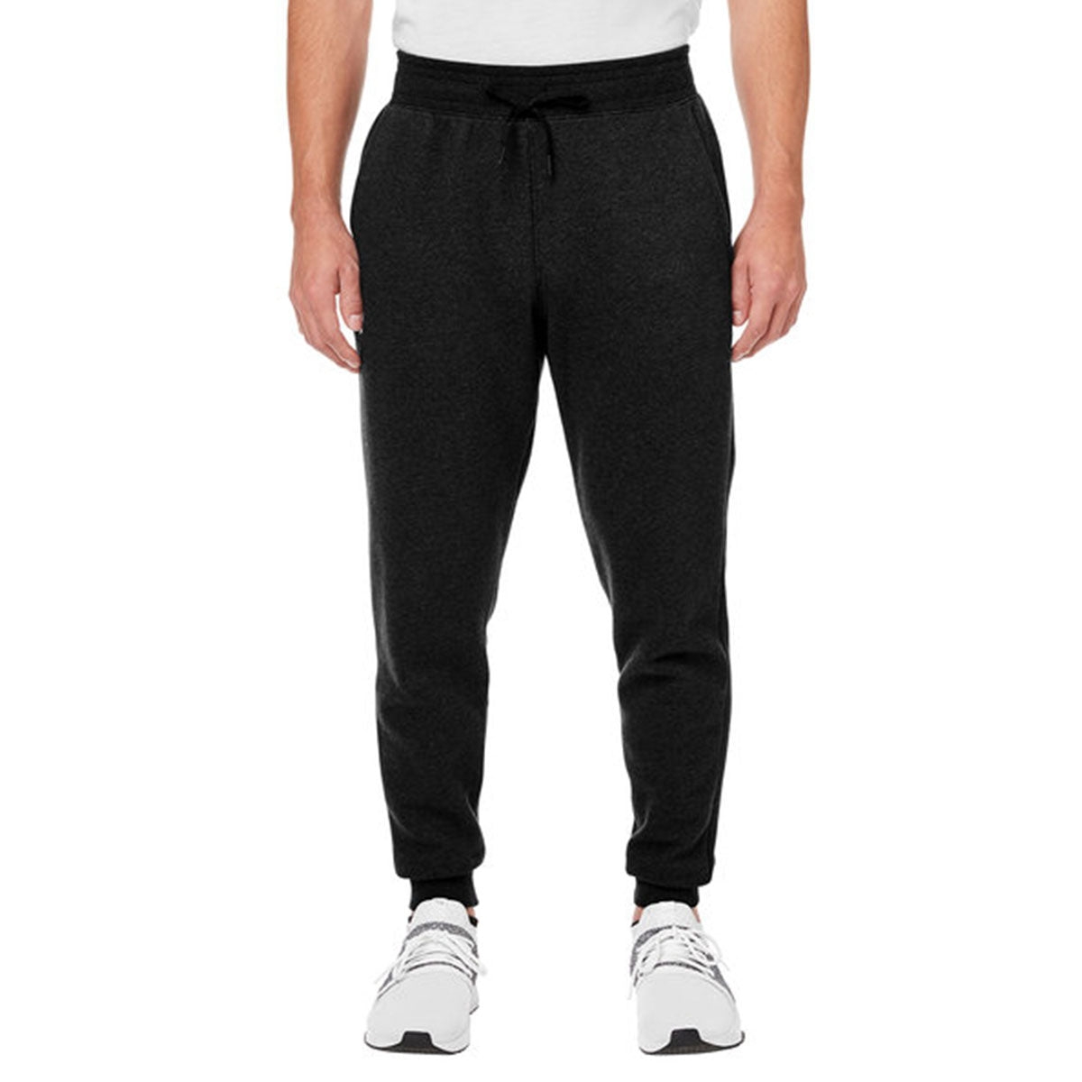 Under Armour Fleece Joggers are black, with an adjustable waistband and cuffed ankles. They feature side pockets and are paired with white athletic shoes.