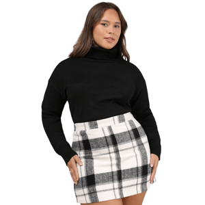 A woman is wearing a black turtleneck sweater paired with a high-waisted black and white plaid skirt.