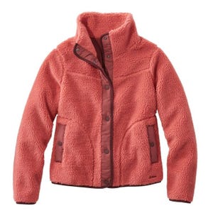 A coral-colored, fleece-lined jacket with a high collar, snap button closure, and two front pockets with contrasting trim.