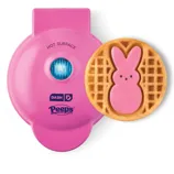 Pink Dash mini waffle maker with a Peeps design imprint, creating waffles resembling the iconic candy shape.