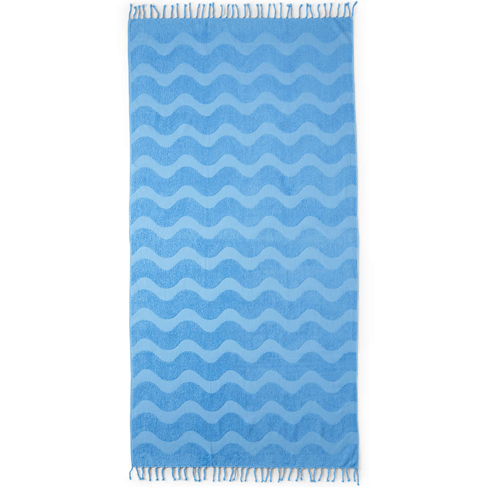 A blue towel with wavy patterns and tassels along the edges.