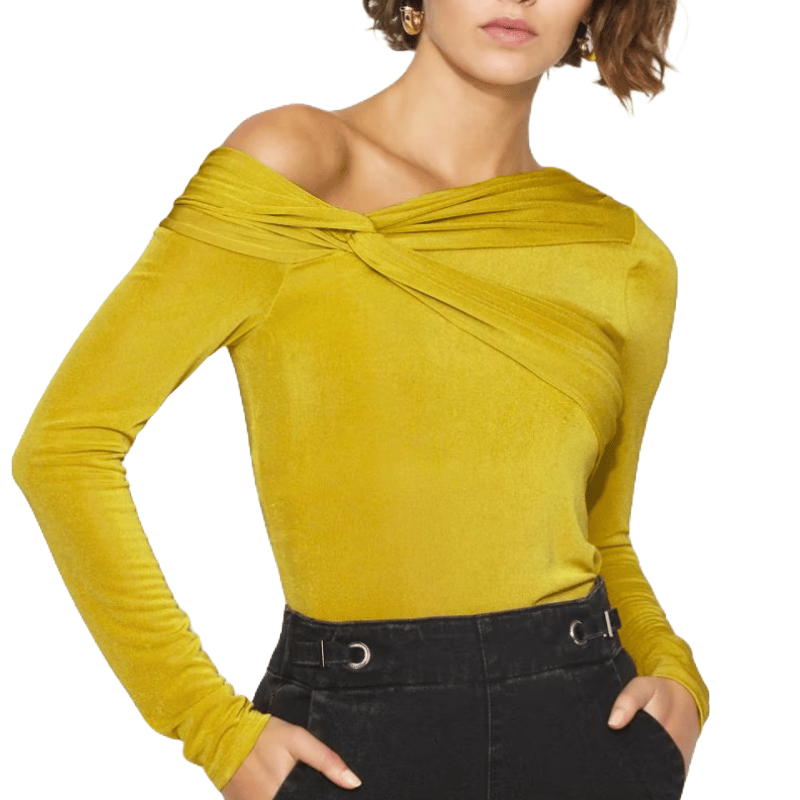A yellow, off-the-shoulder, long-sleeve top with a twisted knot design is paired with high-waisted, black pants featuring belt loops and eyelet details.