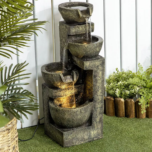 A tiered outdoor fountain with built-in lights, designed to imitate stacked stone bowls.