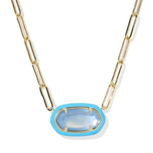 Gold chain necklace with a vibrant blue faceted stone set in a light blue bezel.