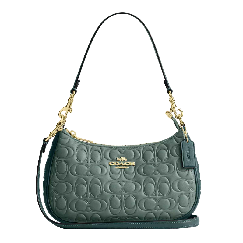 Dark teal Coach Teri Shoulder Bag with embossed logo pattern, gold-toned hardware, and detachable strap. Features a signature tag and zip closure for a stylish, versatile design.