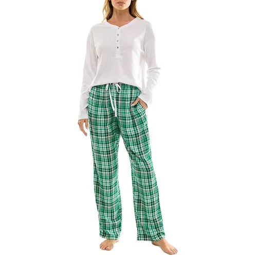 A person is wearing a long-sleeve white henley shirt paired with green plaid drawstring pajama pants.