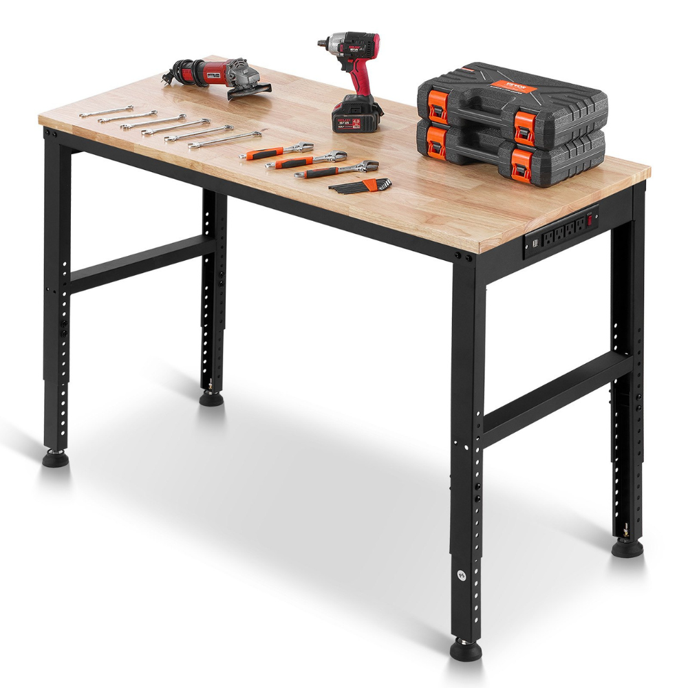 A workbench with a wooden top and adjustable metal legs, equipped with a built-in power strip. Tools include a cordless drill, angle grinder, wrenches, screwdrivers, and stacked tool cases.
