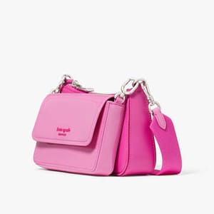 A pink crossbody bag with a silver chain strap and a front flap closure.
