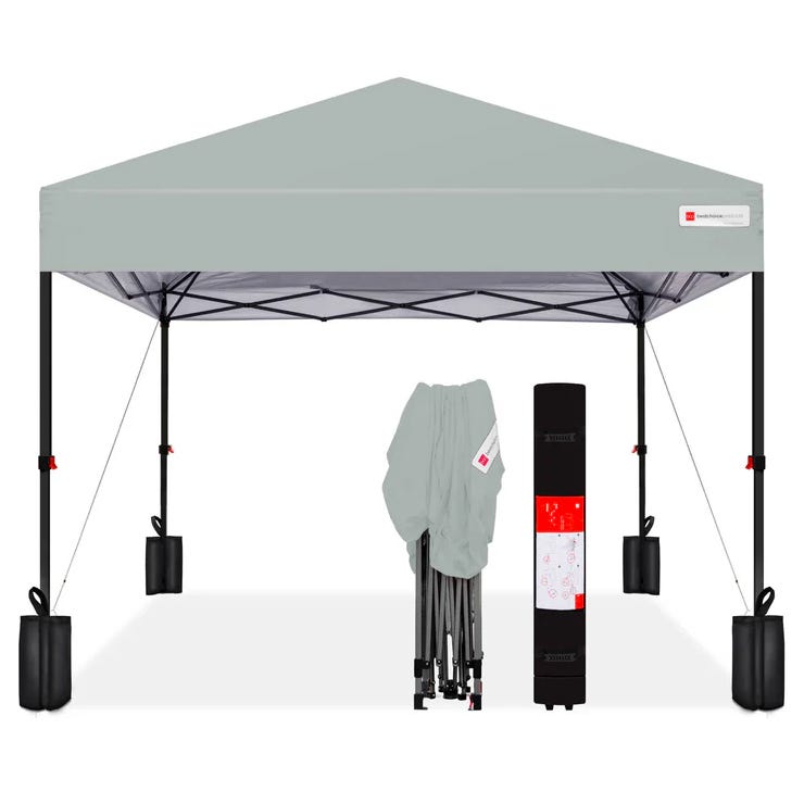 A gray pop-up canopy tent with black legs and stabilizing weights, including a folded frame and a carrying case.