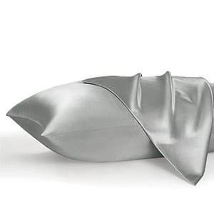 Two satin pillowcases in a silver color with a smooth, shiny finish, displayed partially unfolded.