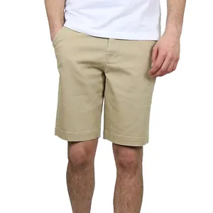 A person is wearing beige knee-length shorts and a white T-shirt, showcasing casual summer attire.