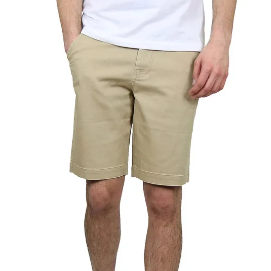 A person is wearing beige knee-length shorts and a white T-shirt, showcasing casual summer attire.