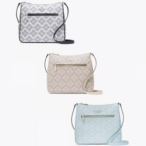 Three crossbody bags with floral patterns in different shades of grey and blue, featuring front zippers and brand logo plaques.