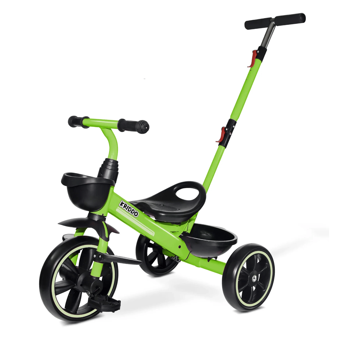 Green tricycle for kids with a push handle and a small front basket.