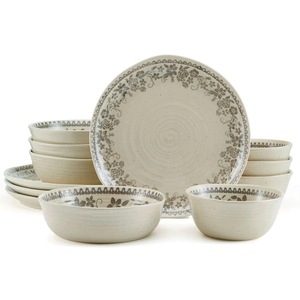 A beige ceramic dinnerware set featuring a floral pattern includes plates and bowls, each adorned with intricate gray designs along the edges.