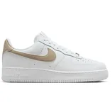 White low-top sneakers with a gold swoosh and heel tab, featuring a classic design and perforated toe box.