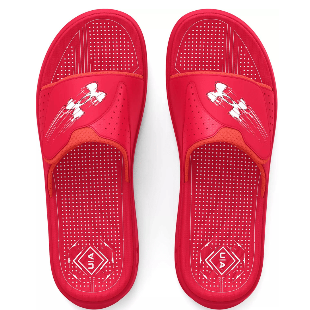 A pair of red slip-on sandals with perforated footbeds and a distinctive logo on the strap.