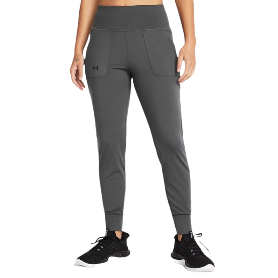 Under Armour Motion Joggers are dark gray, with a high waistband and front pockets featuring the Under Armour logo. They have a tapered fit and are paired with black running shoes.