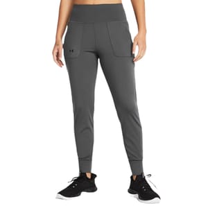 Under Armour Motion Joggers are dark gray, with a high waistband and front pockets featuring the Under Armour logo. They have a tapered fit and are paired with black running shoes.