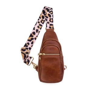 Brown sling bag with a leopard print strap, featuring a gold zipper and multiple compartments.