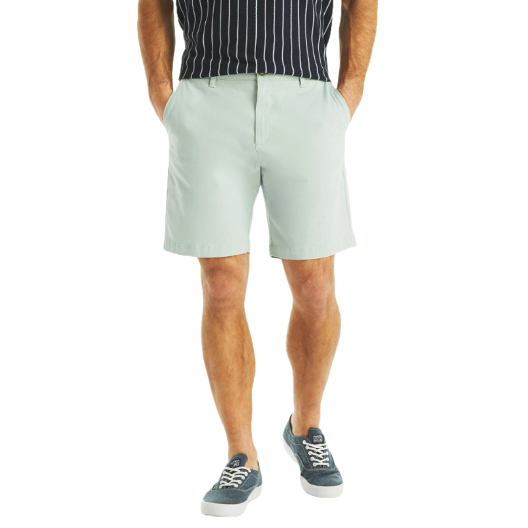 Stretch Deck Shorts are light gray, knee-length shorts with a tailored fit and side pockets, paired with a navy and white striped shirt and blue sneakers.