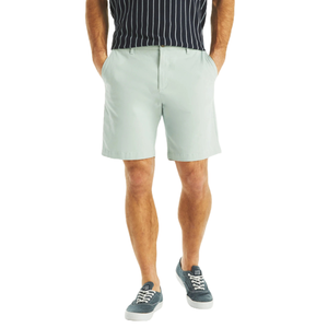 Stretch Deck Shorts are light gray, knee-length shorts with a tailored fit and side pockets, paired with a navy and white striped shirt and blue sneakers.