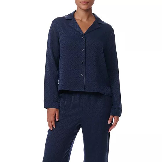 Navy blue pajama set with a long-sleeve button-up top and matching pants adorned with a subtle pattern.