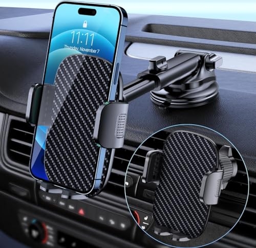 A phone is mounted on a car dashboard using a bracket with a suction cup and clamp arms featuring a carbon fiber pattern.