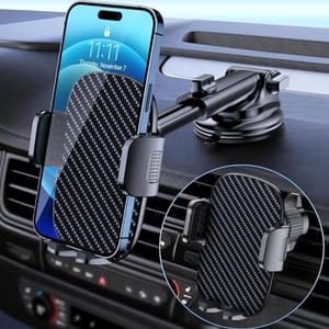 A phone is mounted on a car dashboard using a bracket with a suction cup and clamp arms featuring a carbon fiber pattern.