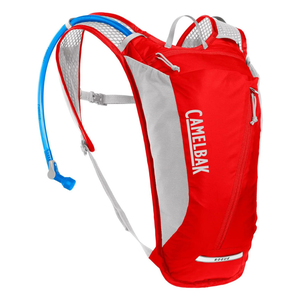 A red CamelBak Rogue hydration pack with a blue drinking tube, designed for carrying water during outdoor activities like hiking and cycling.
