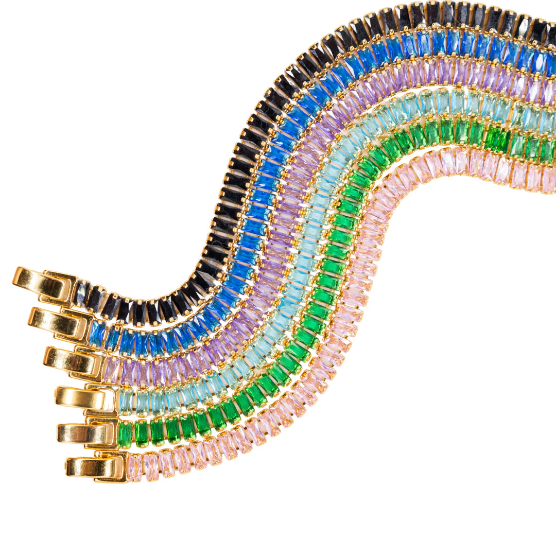 Gold bracelets featuring rows of colorful baguette-cut gemstones in black, blue, purple, teal, green, and pink.