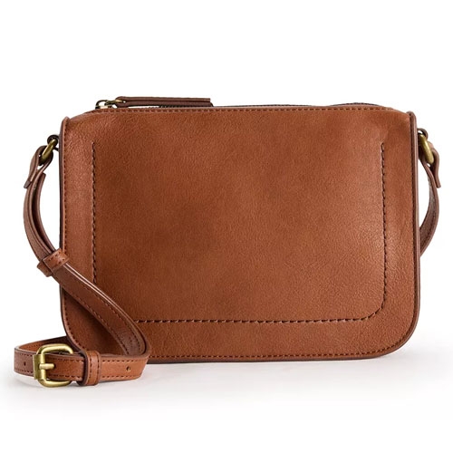 A brown leather shoulder bag with a rectangular shape, featuring a simple design and an adjustable strap with brass hardware.