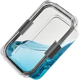 A clear, rectangular food container with a snap-lock lid is shown tilted, holding blue liquid to demonstrate its leak-proof feature.