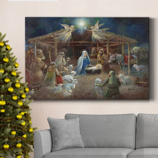 A Christmas-themed painting of the nativity scene is displayed above a gray sofa next to a decorated Christmas tree with gold ornaments.